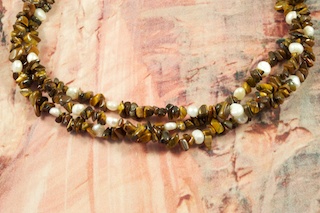 Beautiful 3 strand Necklace featuring Genuine Tiger's Eye, Freshwater Pearls and Penshell Heishi. Sterling Silver Cones, Extender and Clasp.  Created by Santo Domingo Artist Carol Pacheco. The Santo Domingo Pueblo is in New Mexico, near Santa Fe. 